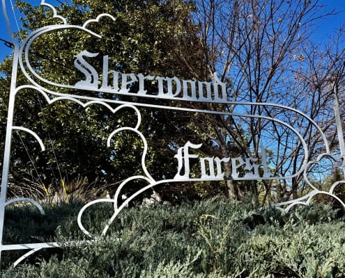 Classic Sherwood Forest iron sign at the intersection of Friar Tuck Road and Little John Trail in Sherwood Forest, Atlanta.